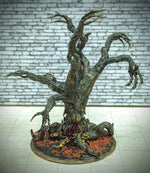 a sculpture of a tree with a brick wall in the background
