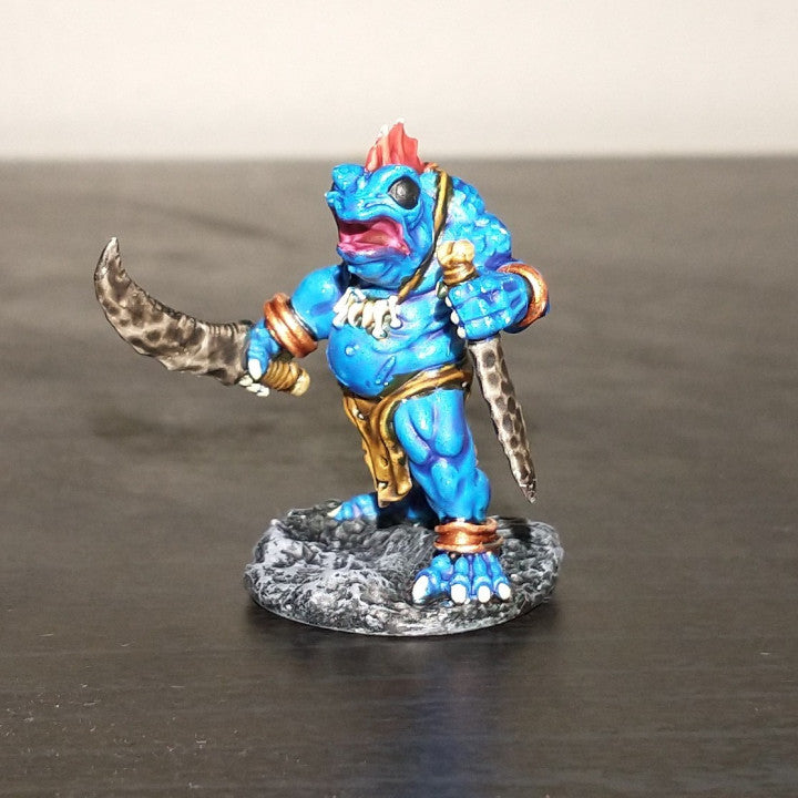 a toy figurine of a blue creature holding a sword