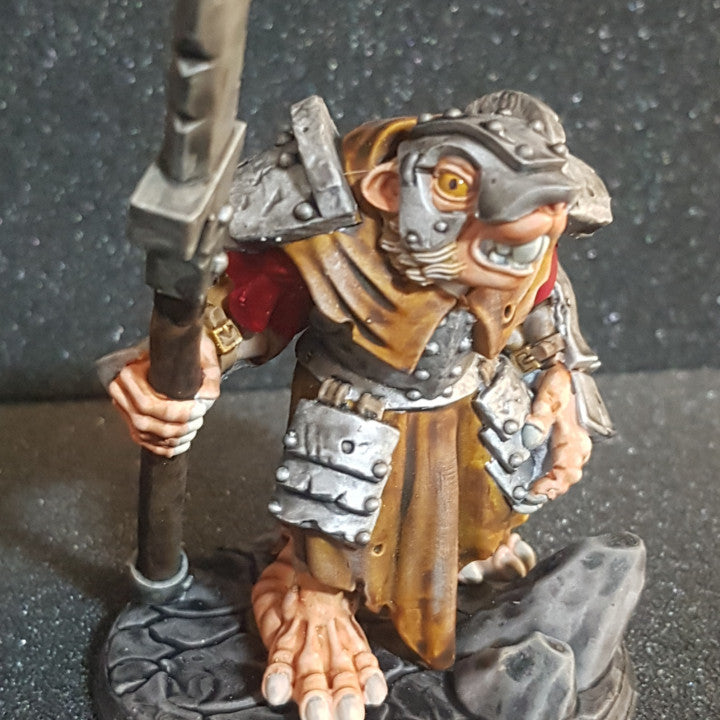 a figurine of a troll holding a knife