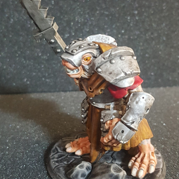 a figurine of a man in armor holding a sword