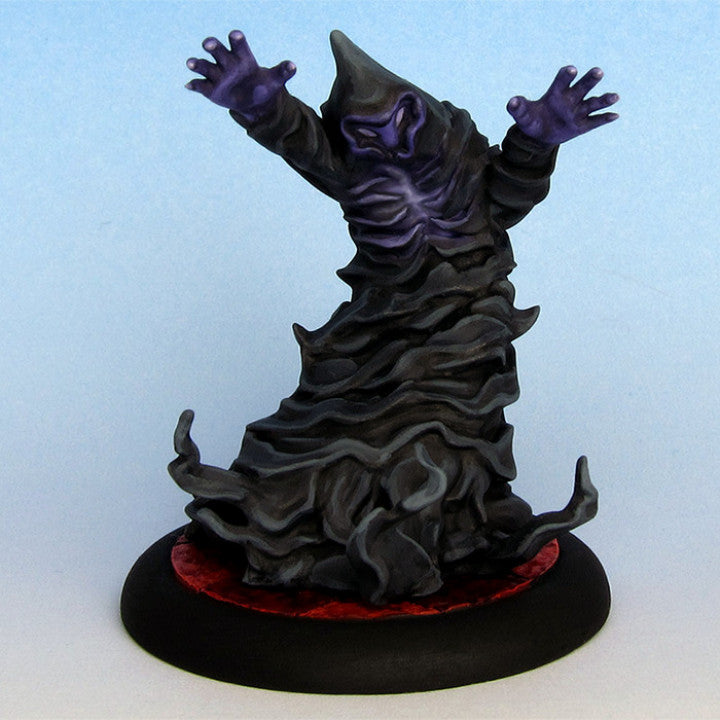 a figurine of a creepy creature on a black base